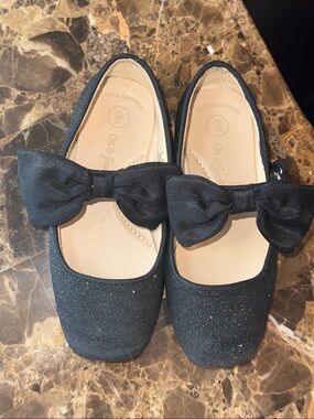 Size 9T toddler sparkly black flats with hook and loop closure with bow.